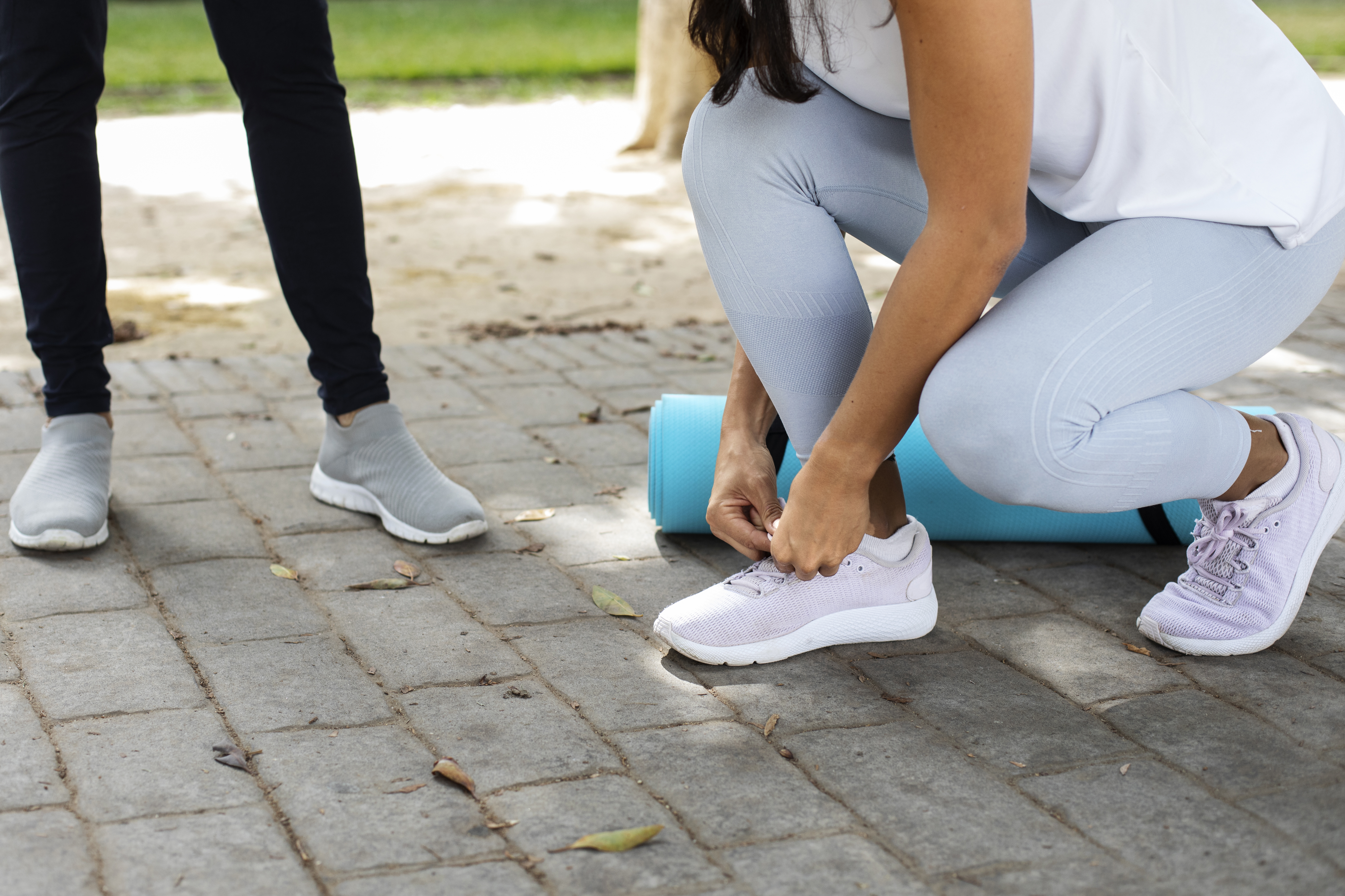 Friends doing yoga together in park for custom orthotics and movement support